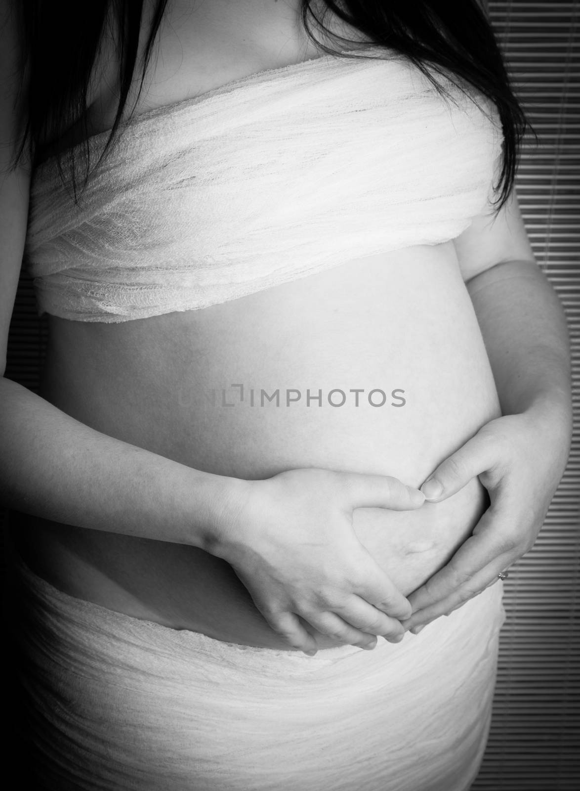 Pregnant woman with hands over her stomach