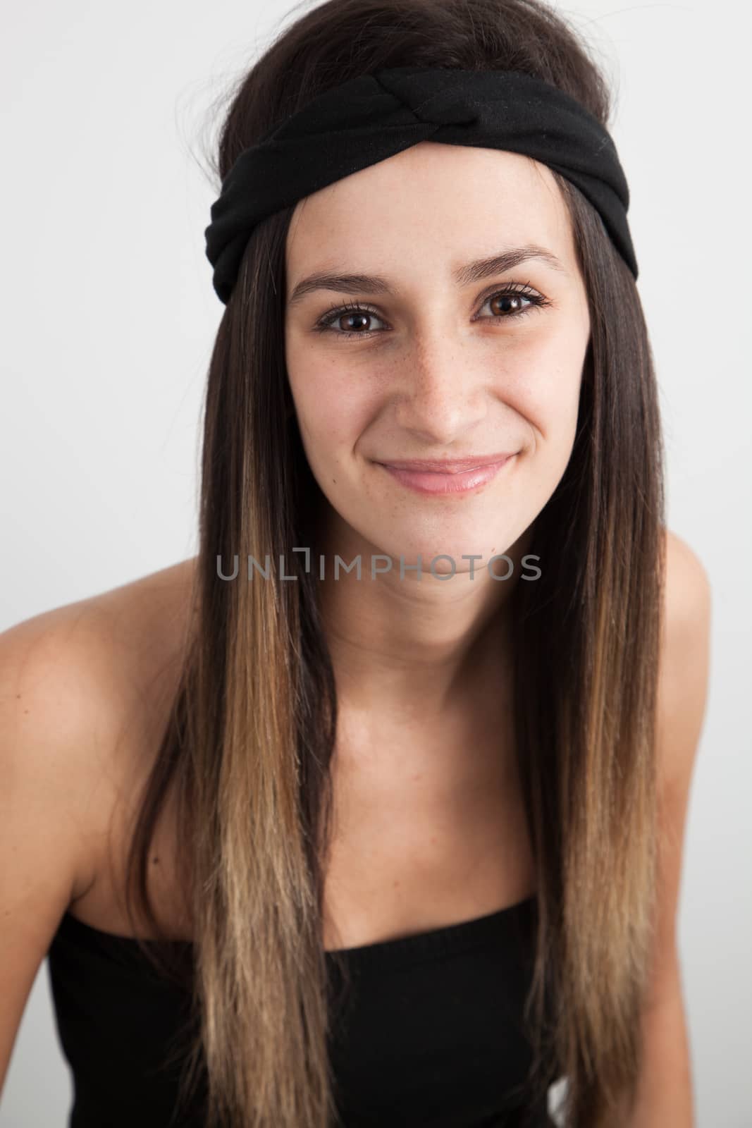 Young caucasian brunette woman on a white background