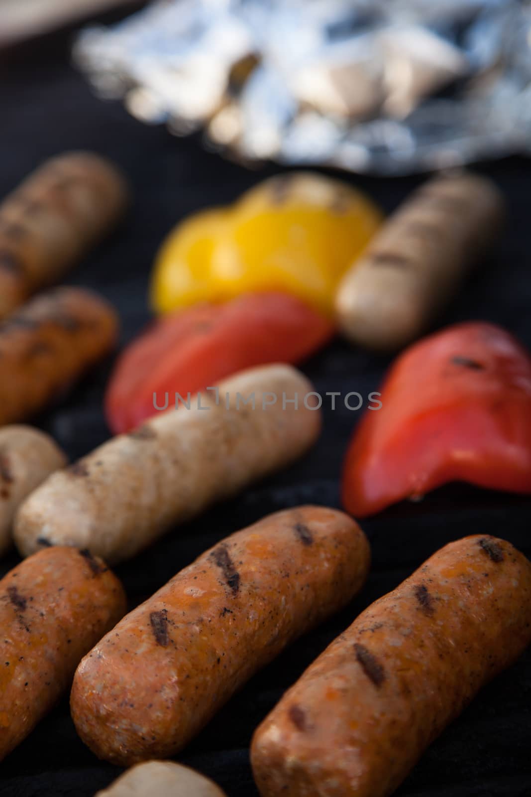 Sausages and red peper on the grill by Izaphoto