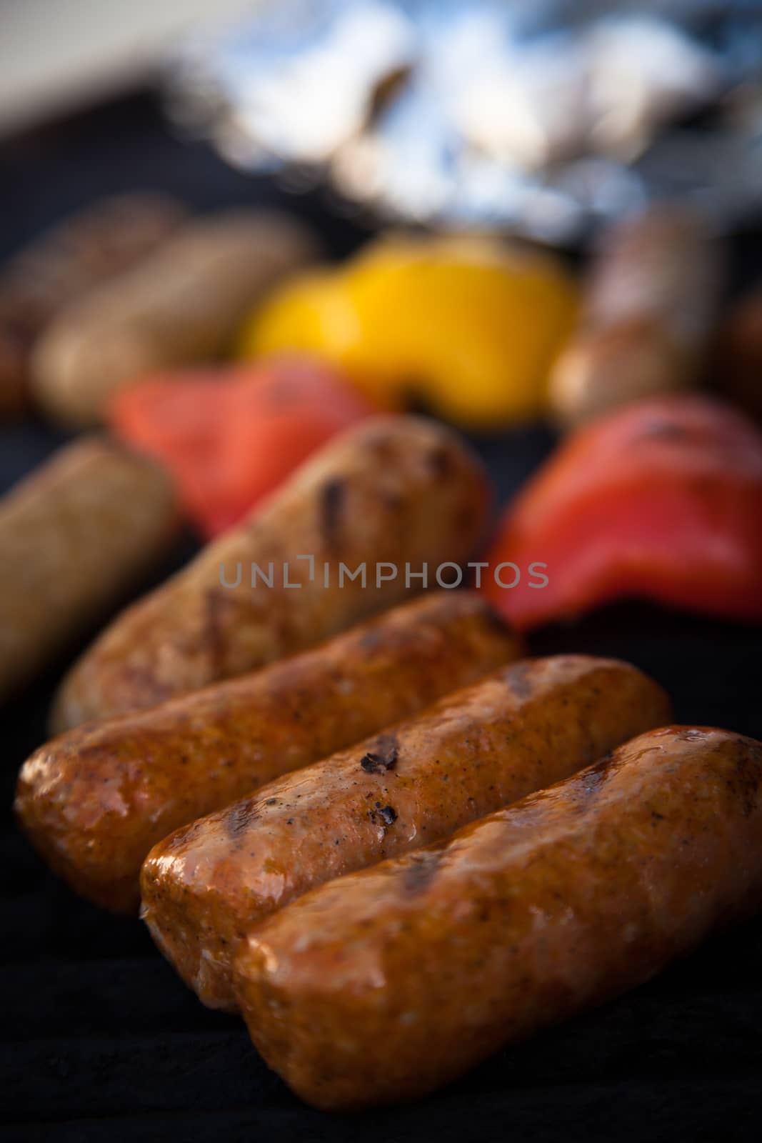 Sausages and red peper on the grill by Izaphoto