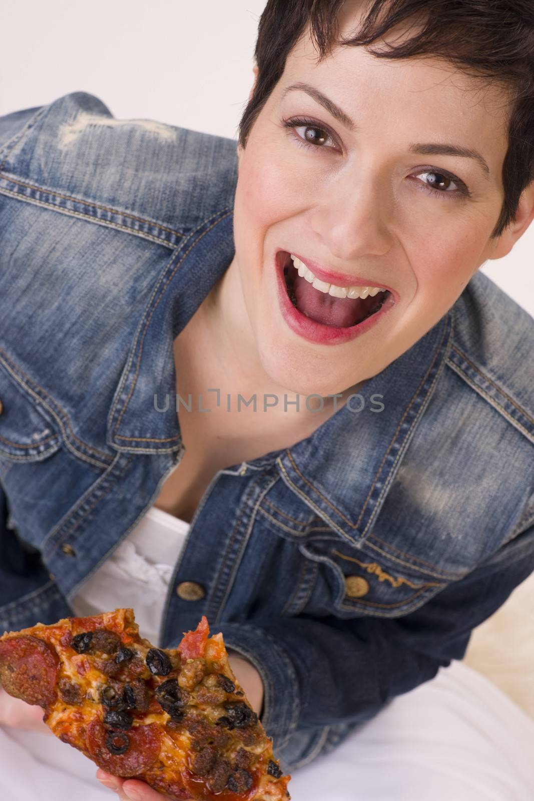 A very excited female enjoys a supreme meat crispy pizza