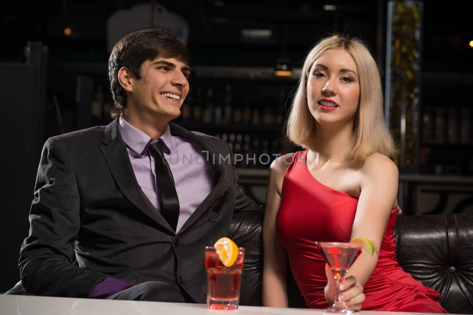 Young couple talking in a nightclub, have fun