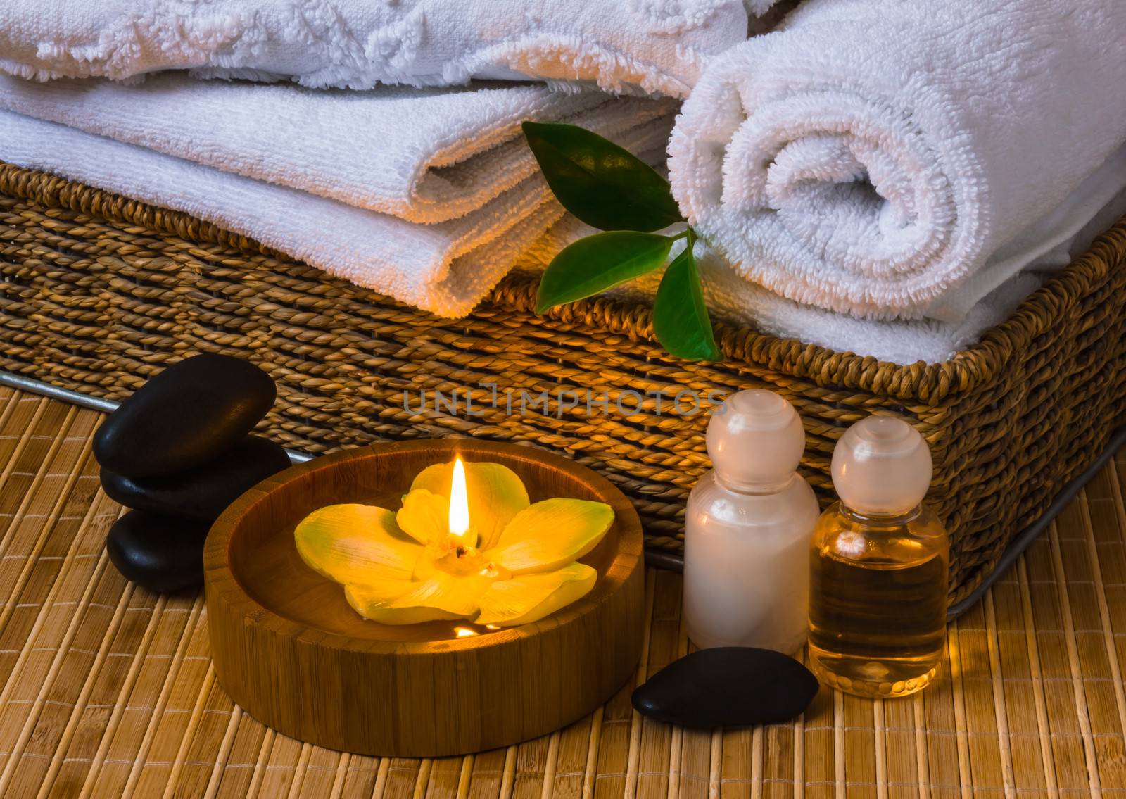 Spa with towels with a candle and other accessories