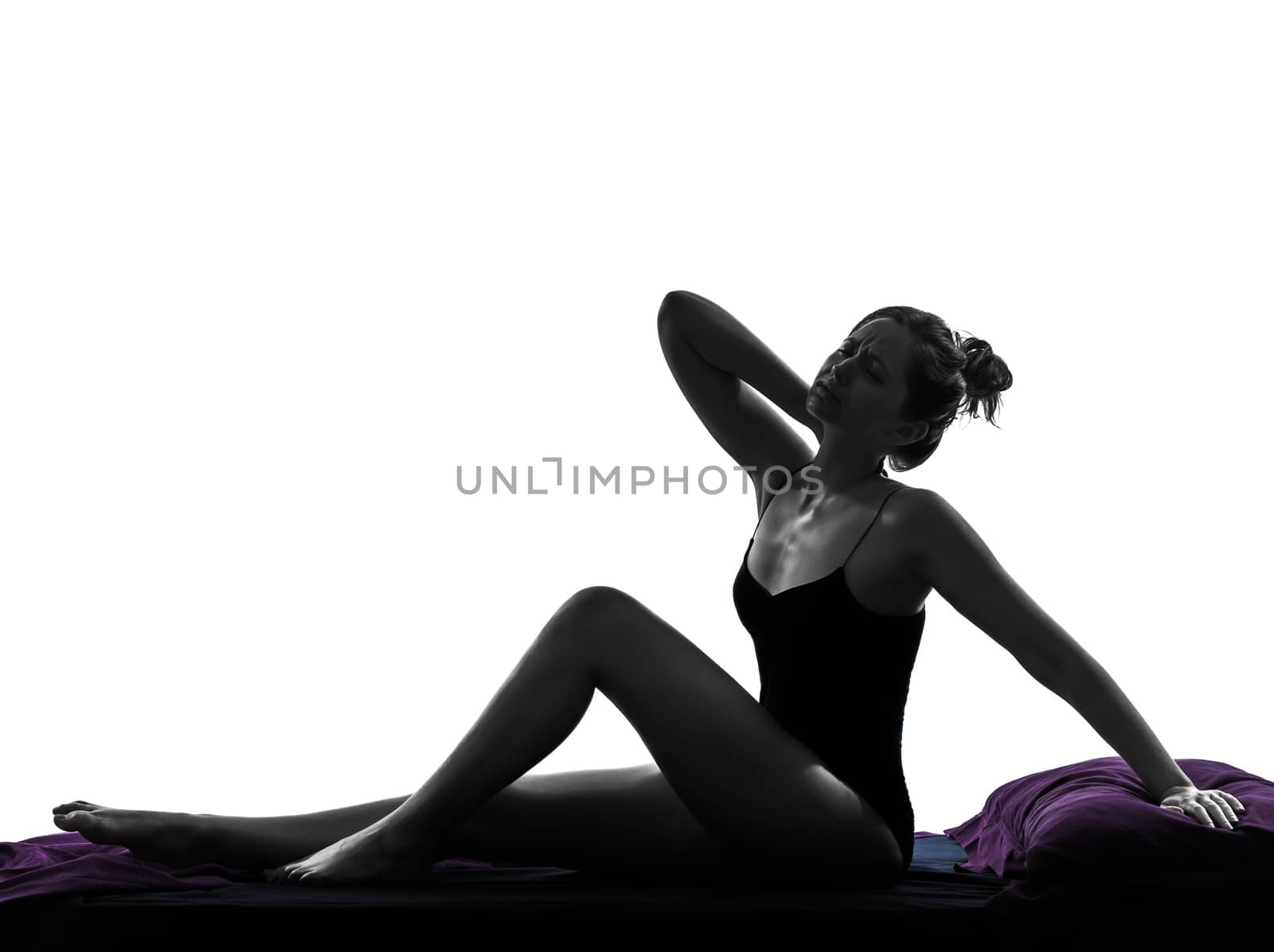 one woman waking up stretching backache sitting in bed silhouette studio on white background