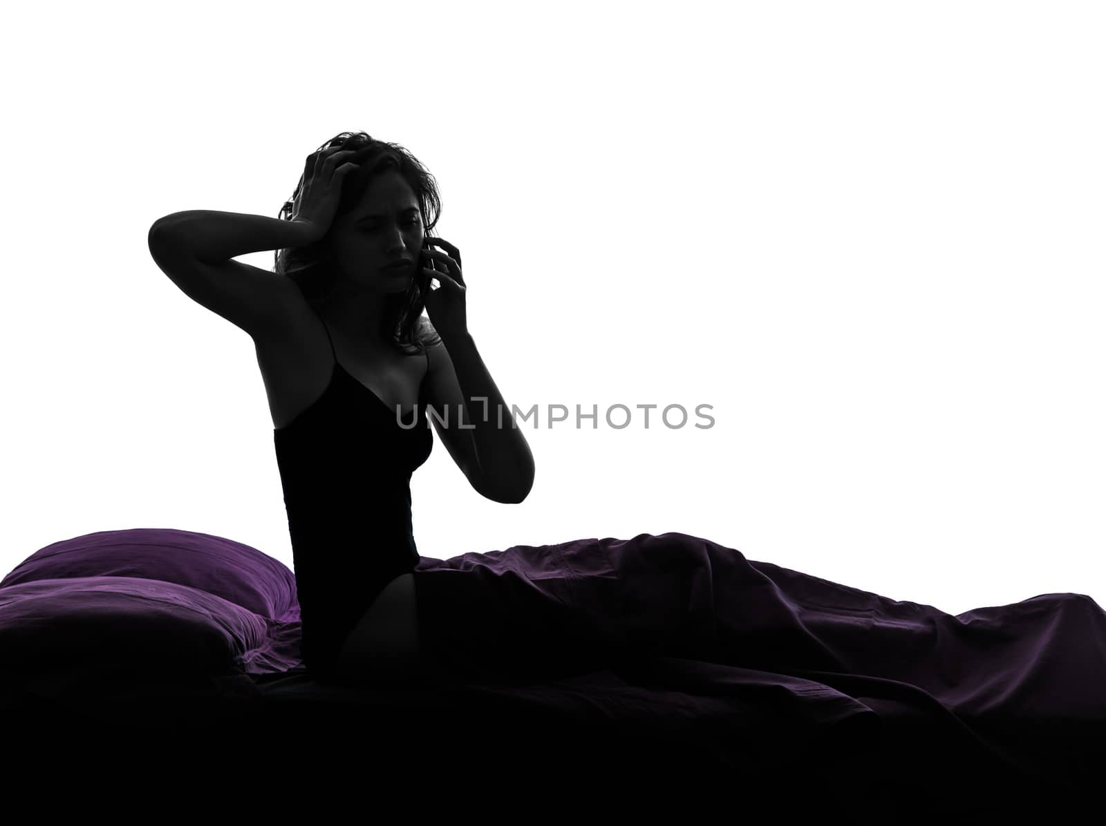 one woman sad on the telephone in bed silhouette studio on white background