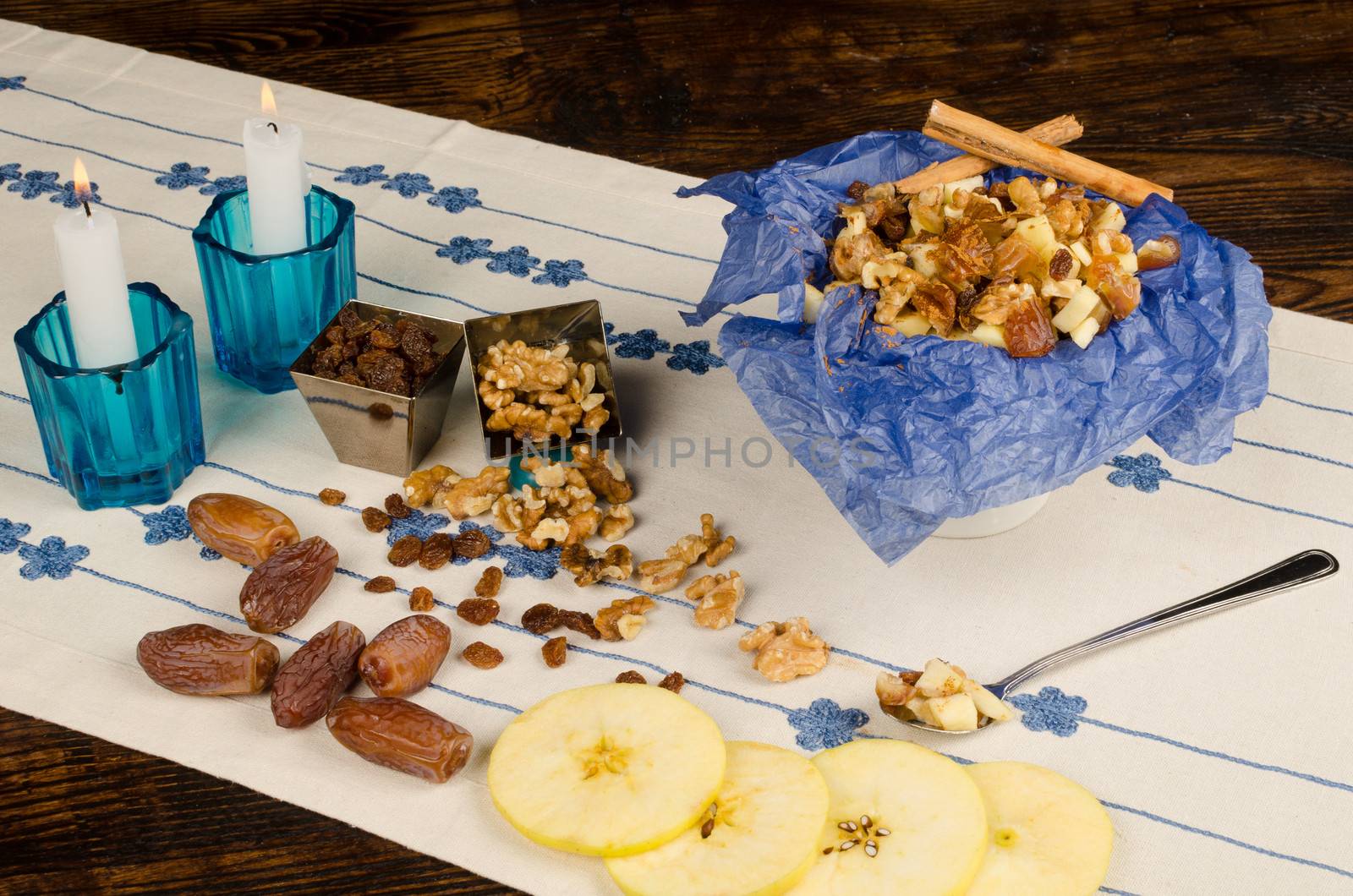 Haroset served on a festive table surrounded by its ingredients