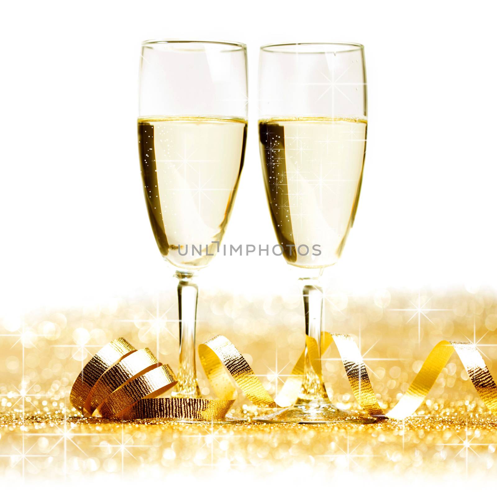 Two champagne glasses and decoration on golden background