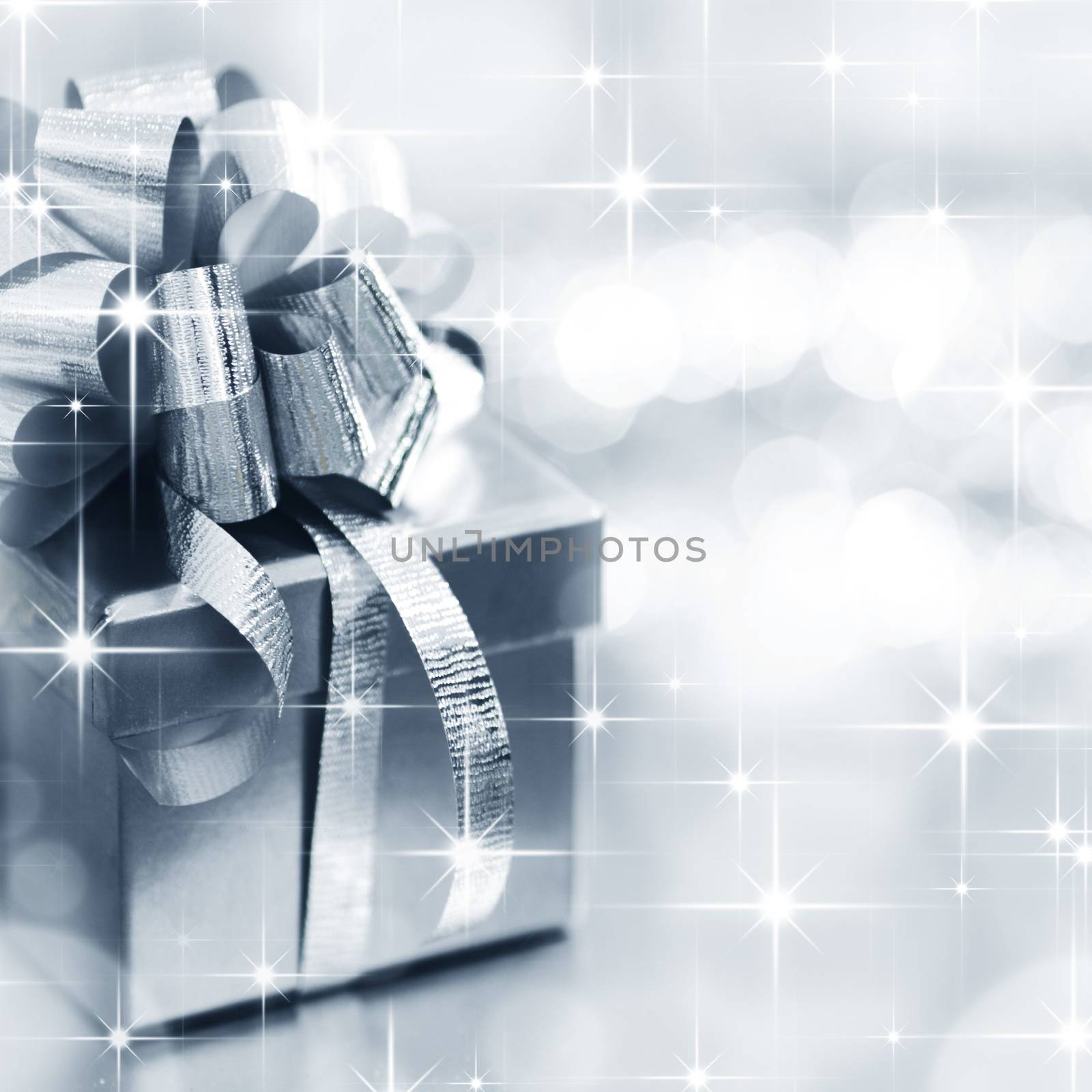 Holiday gift box with decoration on shiny stars background