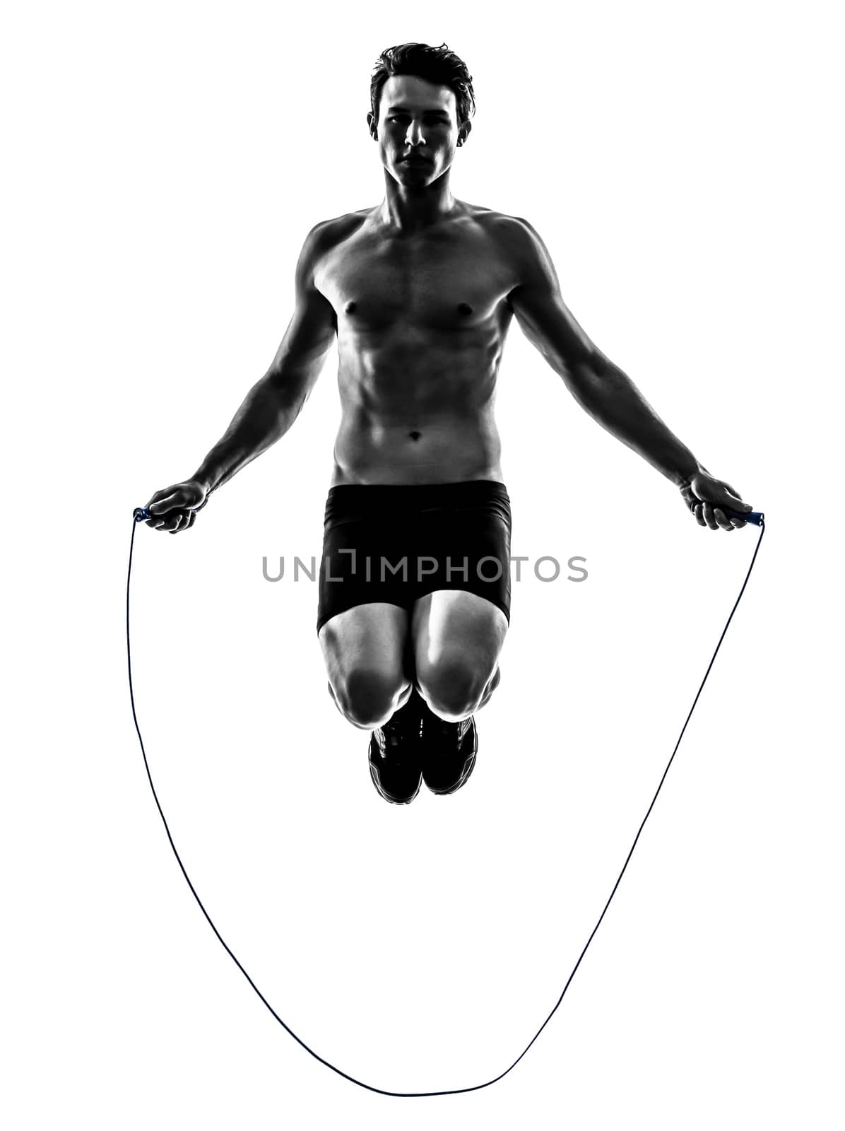 one caucasian man exercising jumping rope in silhouette studio on white background