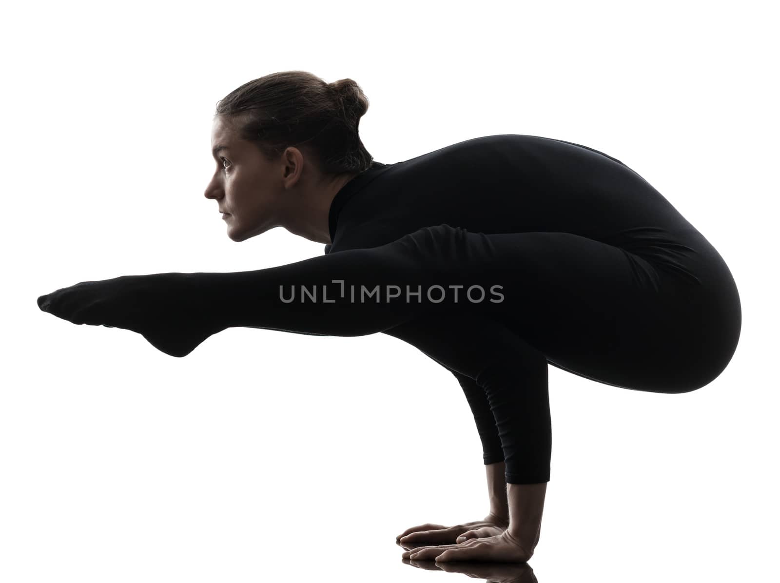 one caucasian woman contortionist practicing gymnastic yoga in silhouette  on white background