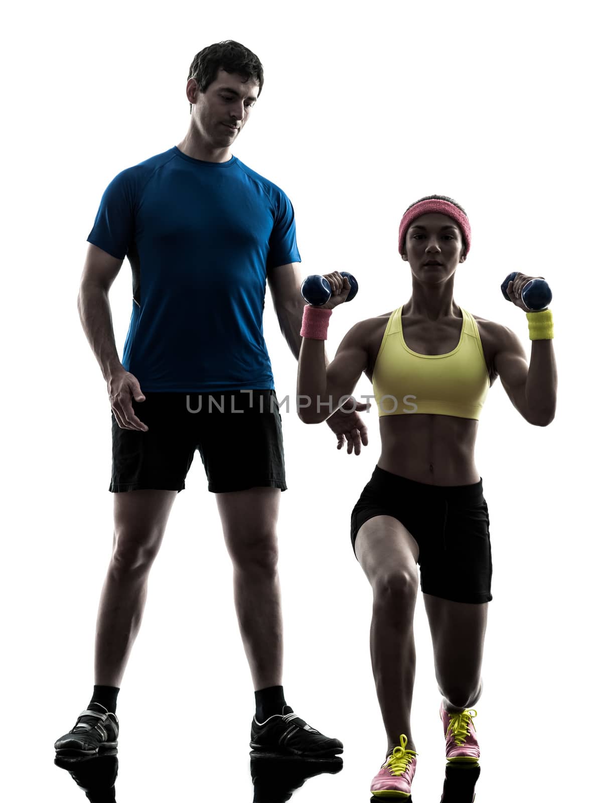 one woman exercising fitness weight training with man coach in silhouette on white background