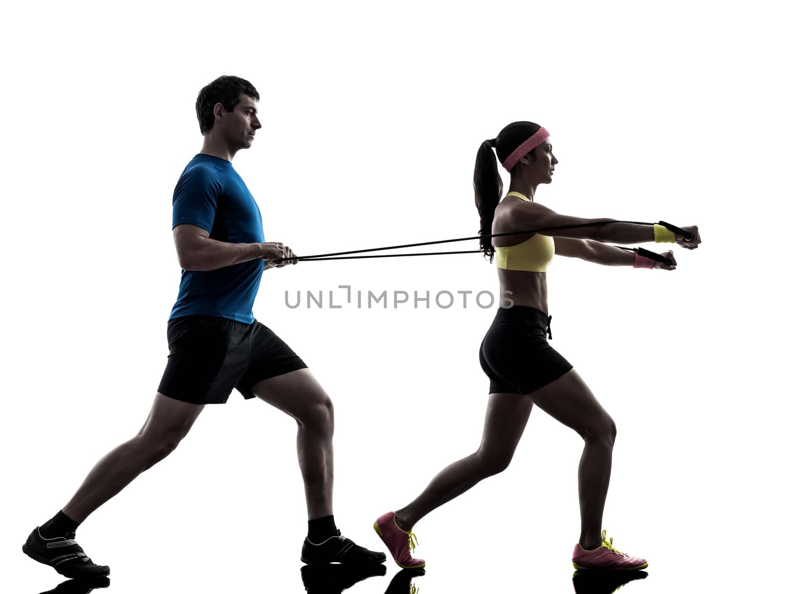 one woman exercising resistance rubber band fitness workout with man coach in silhouette on white background