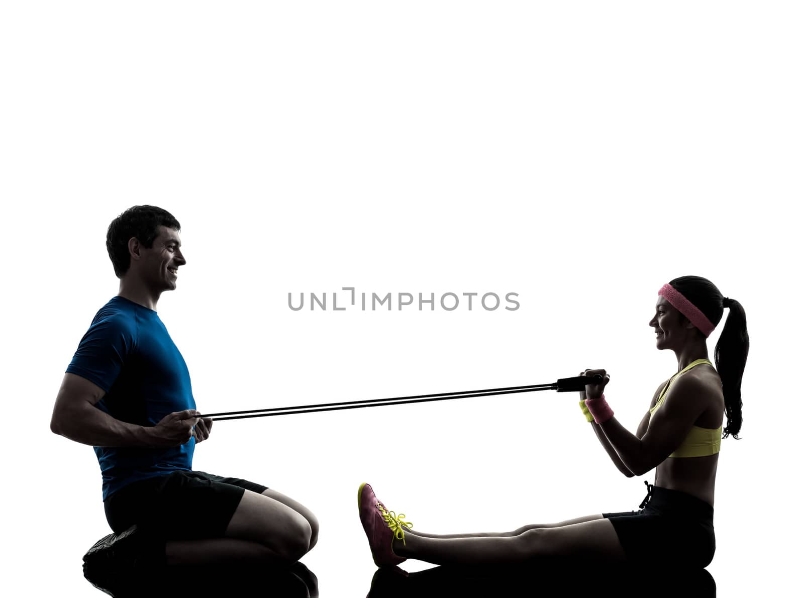 woman exercising fitness resistance  rubber band with man coach  by PIXSTILL
