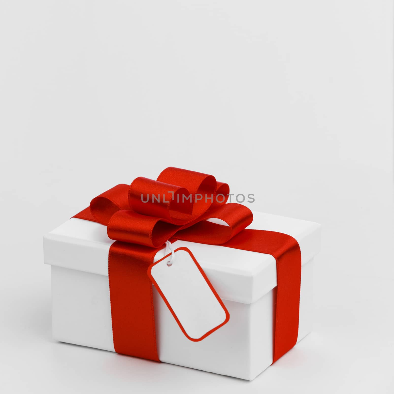 Gift with ribbon and bow on white background