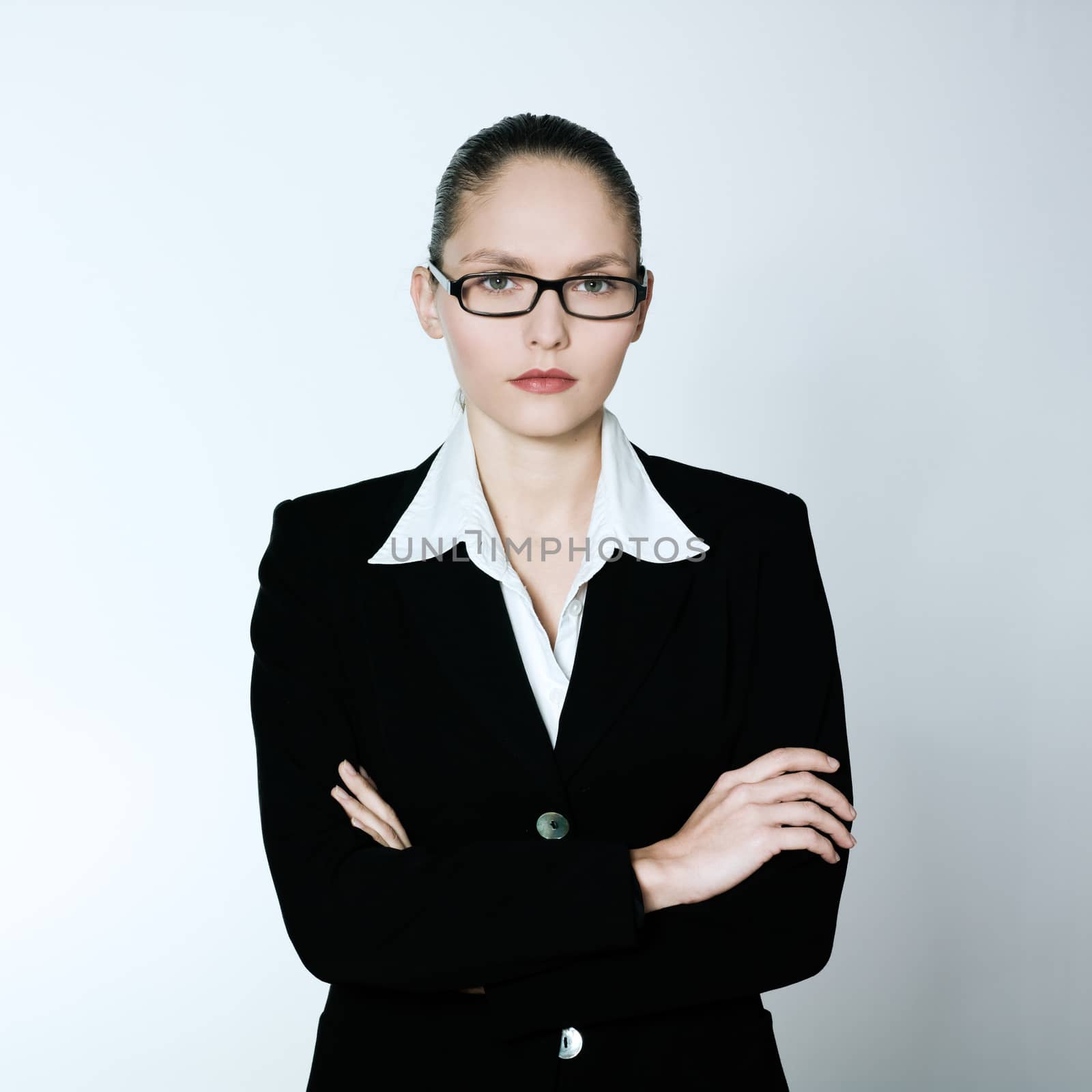 studio shot portrait of one caucasian young serious business woman