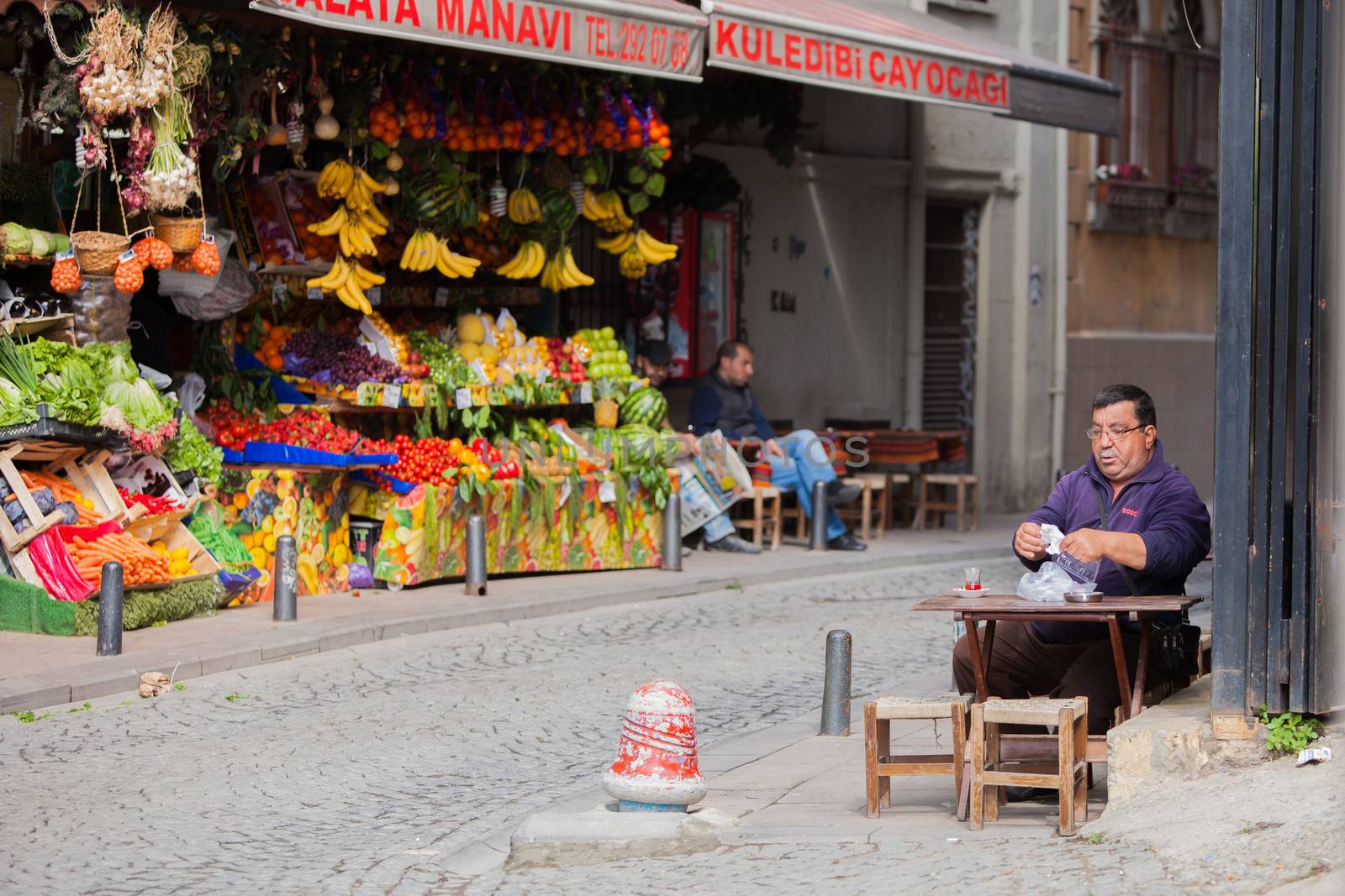 Istanbul, TURKEY ��� APRIL 28: Man enjoys apple tea on a sidewalk on April 28 2012 in Istanbul, Turkey.  Each year patriotic Turks honor those fallen at the battle of Galipoli during World War I.