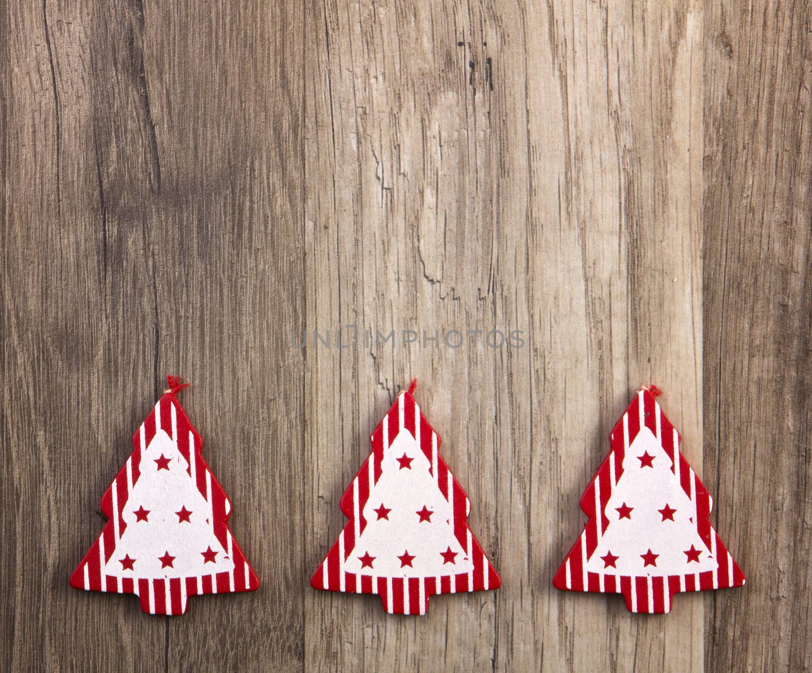 christmas trees red and white on wooden background
