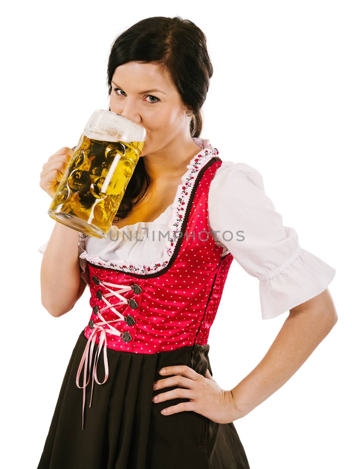 Photo of a beautiful woman wearing traditional dirndl and drinking a huge beer.
