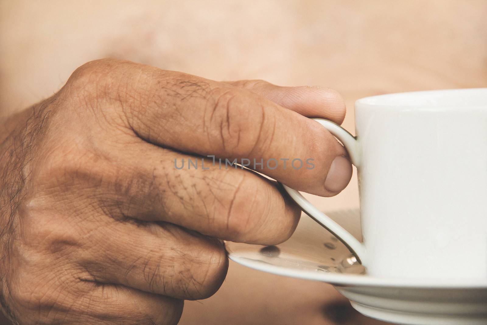 a hand ilfts a cup of tea