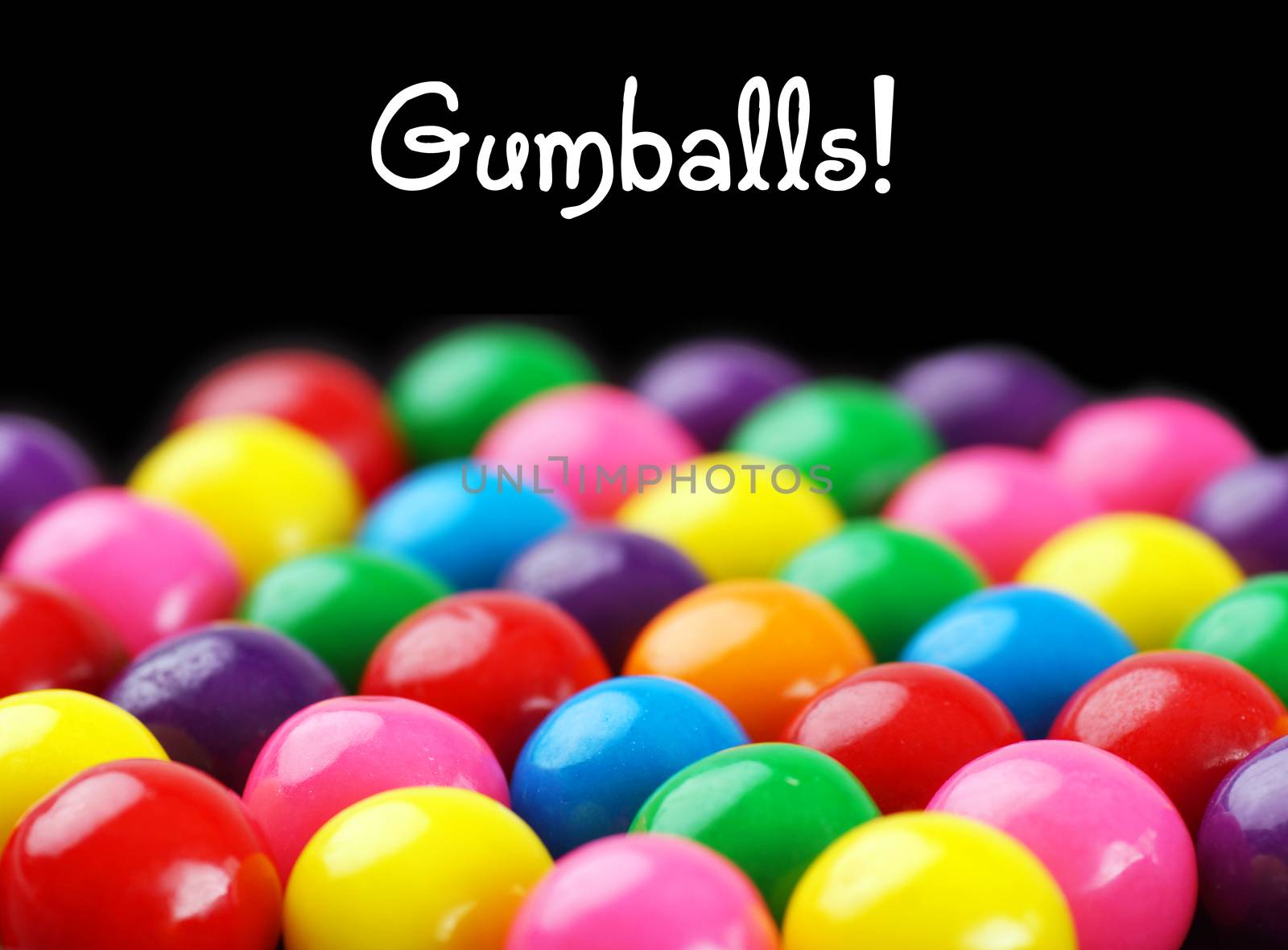 Fun and colorful gumballs on black background with text
