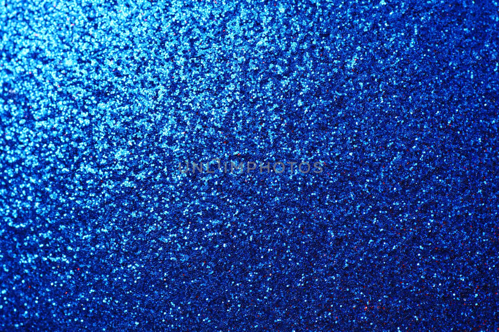 Blue metallic sparkling sequin background with light corner gradient