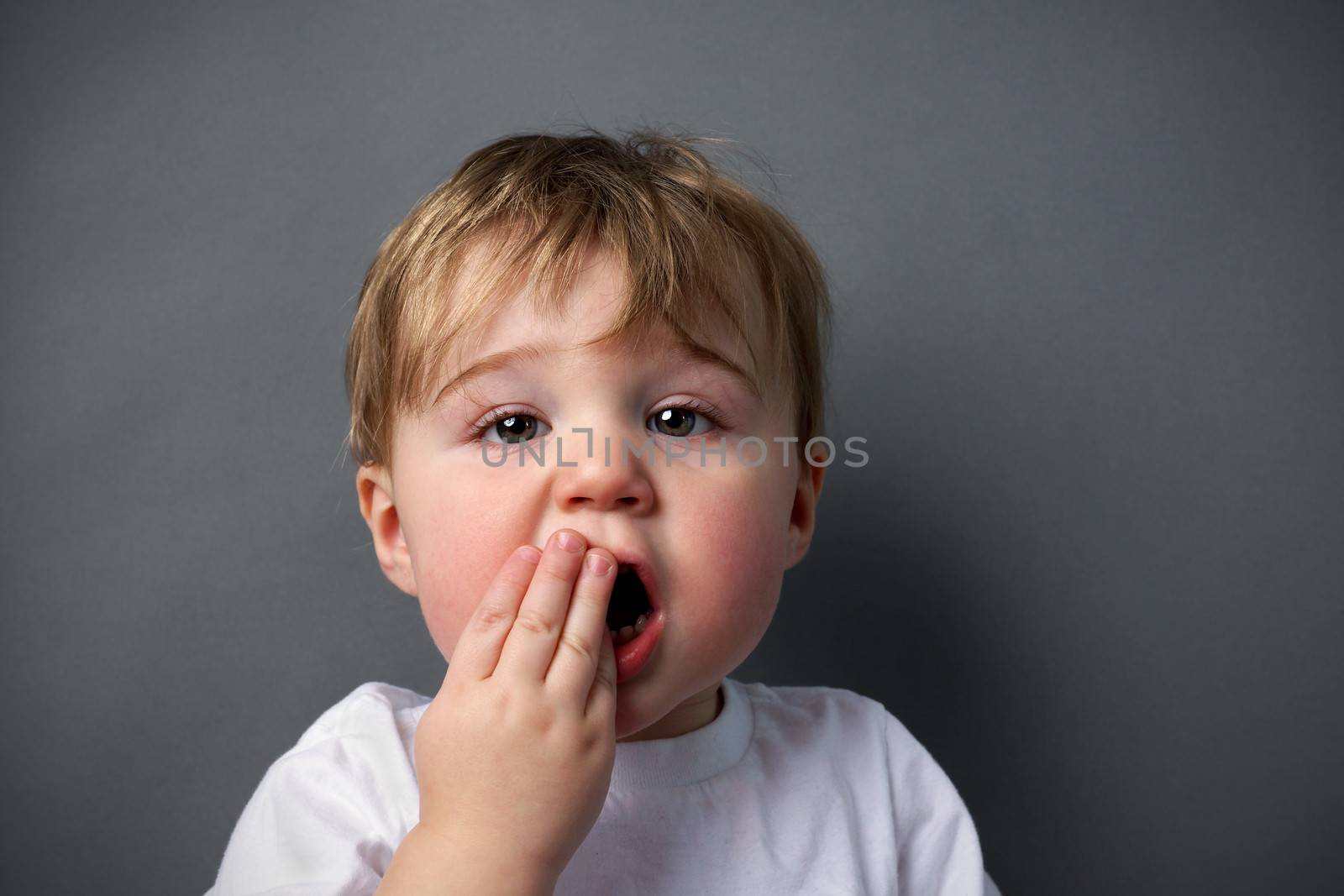 Little boy upset or hurting, toothache or other booboo concept.