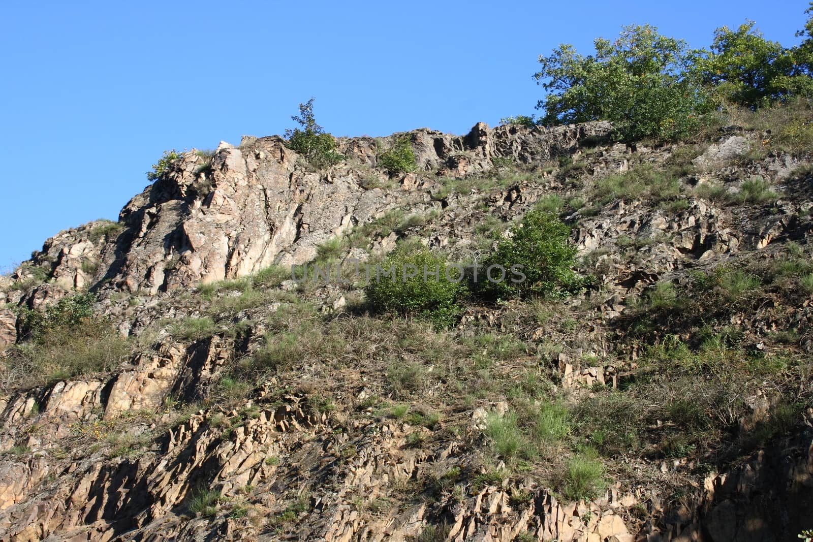 A landscape in the highlands, with rocks, trees and blue sky