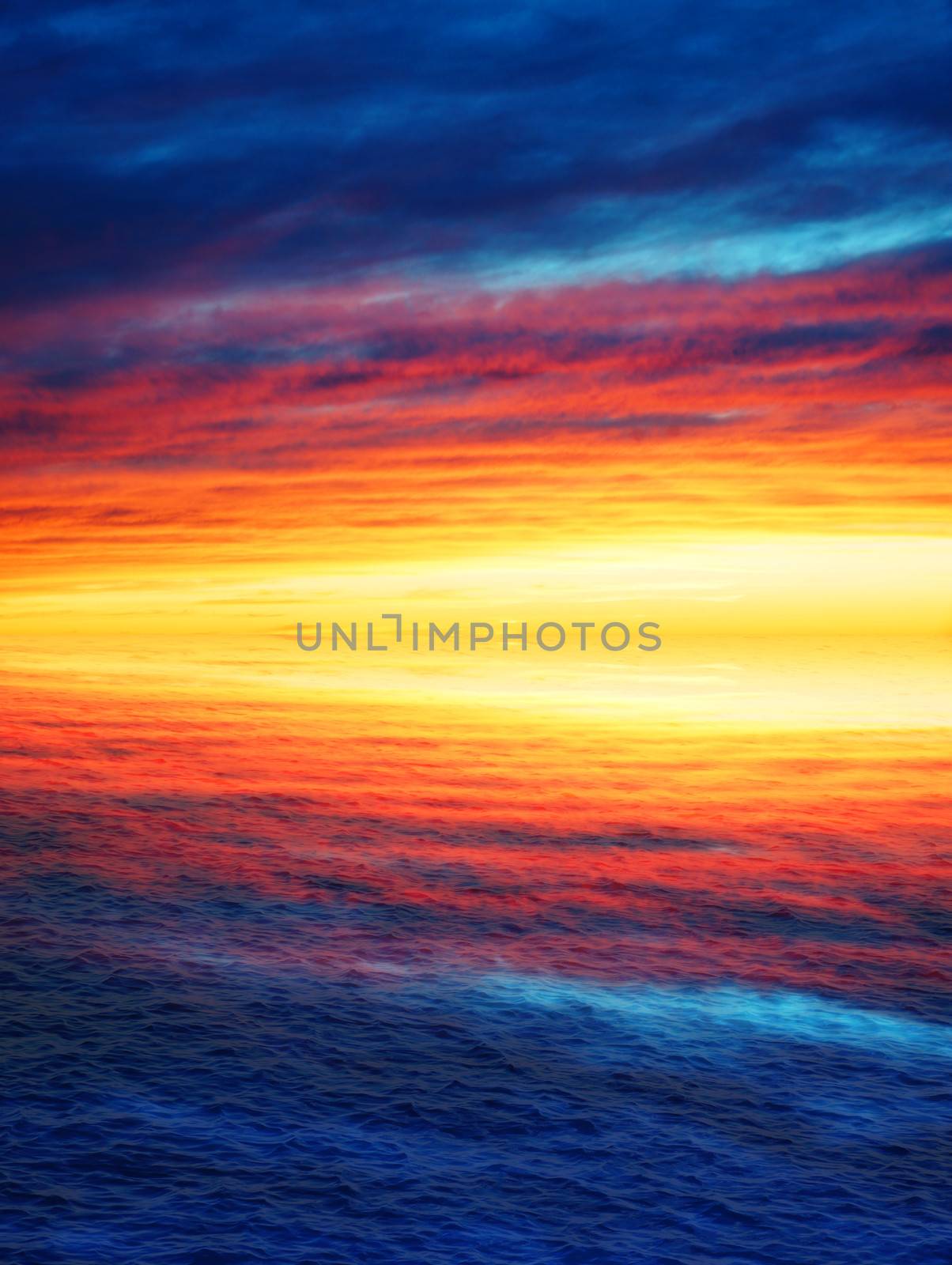 Stunning sunset with very colorful clouds reflected on the waves of the ocean or the sea, nature background