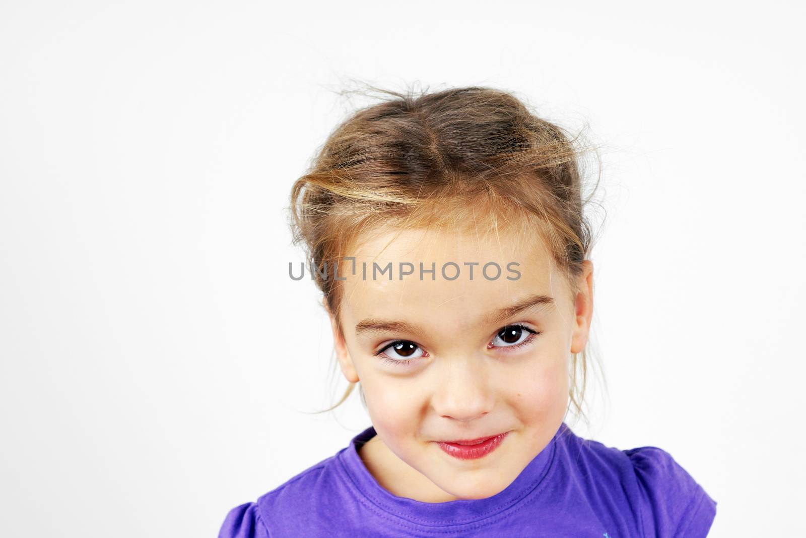 Little blond girl with mishievous face, studio on white