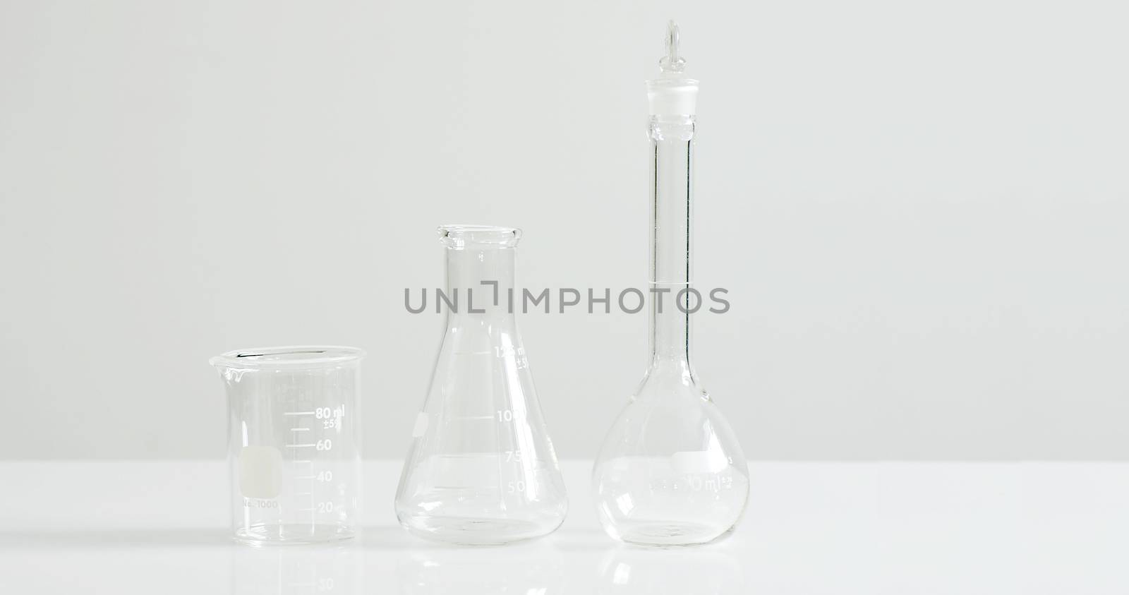 Laboratory glassware on white, stark and sterile concept