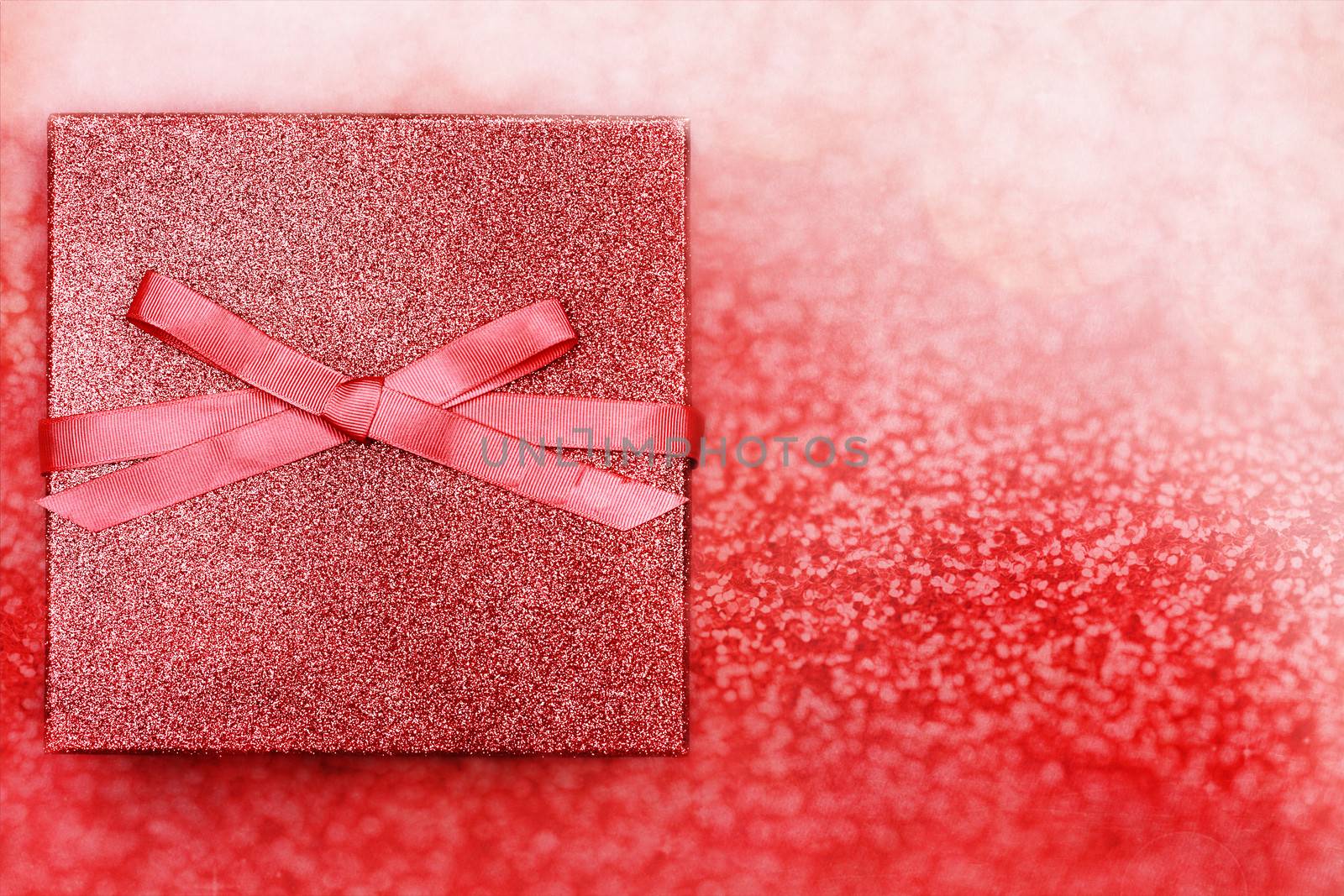 Beautiful gift against a magical red background with copy space.