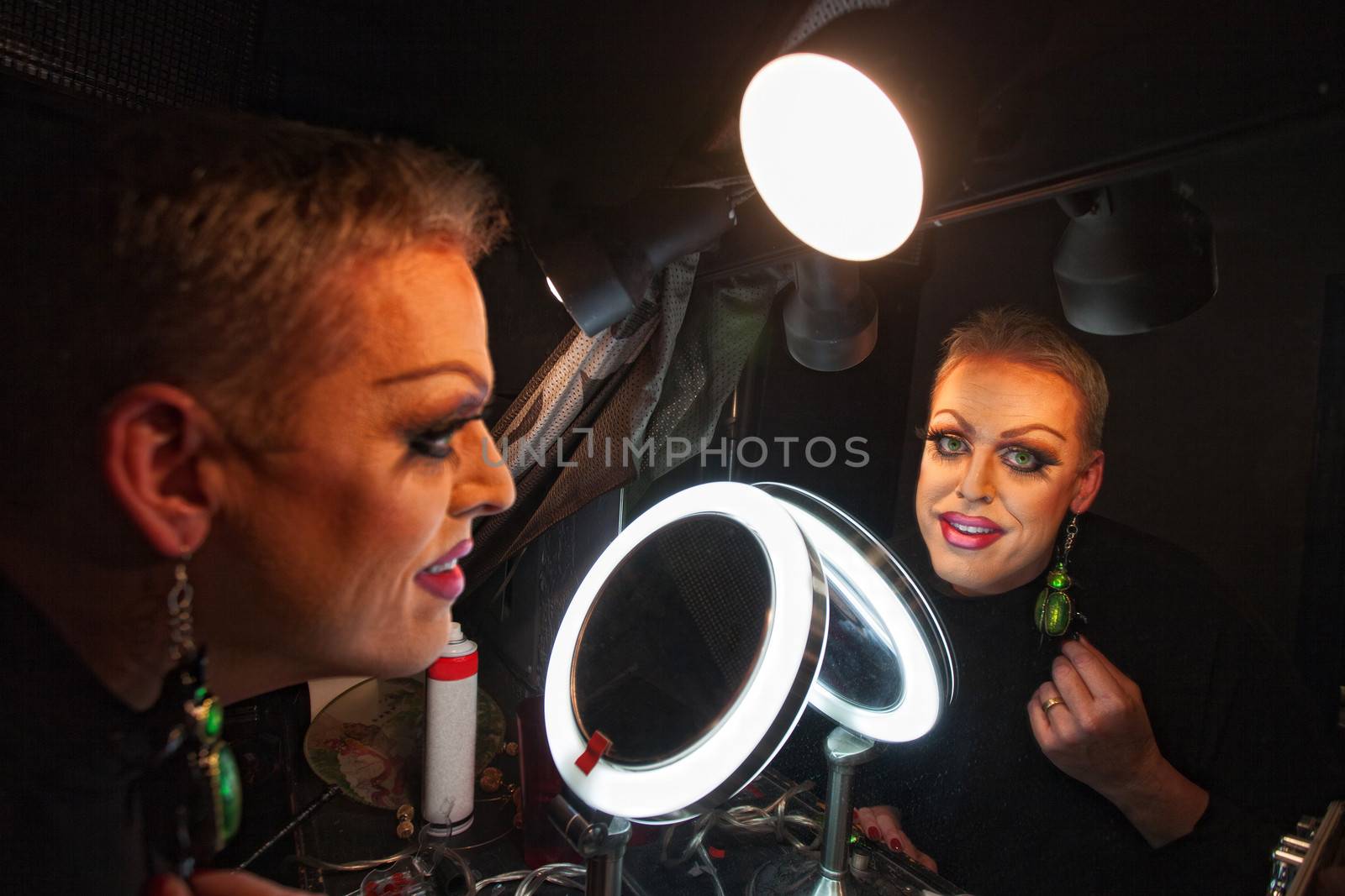 Caucasian drag queen at mirror in dressing room