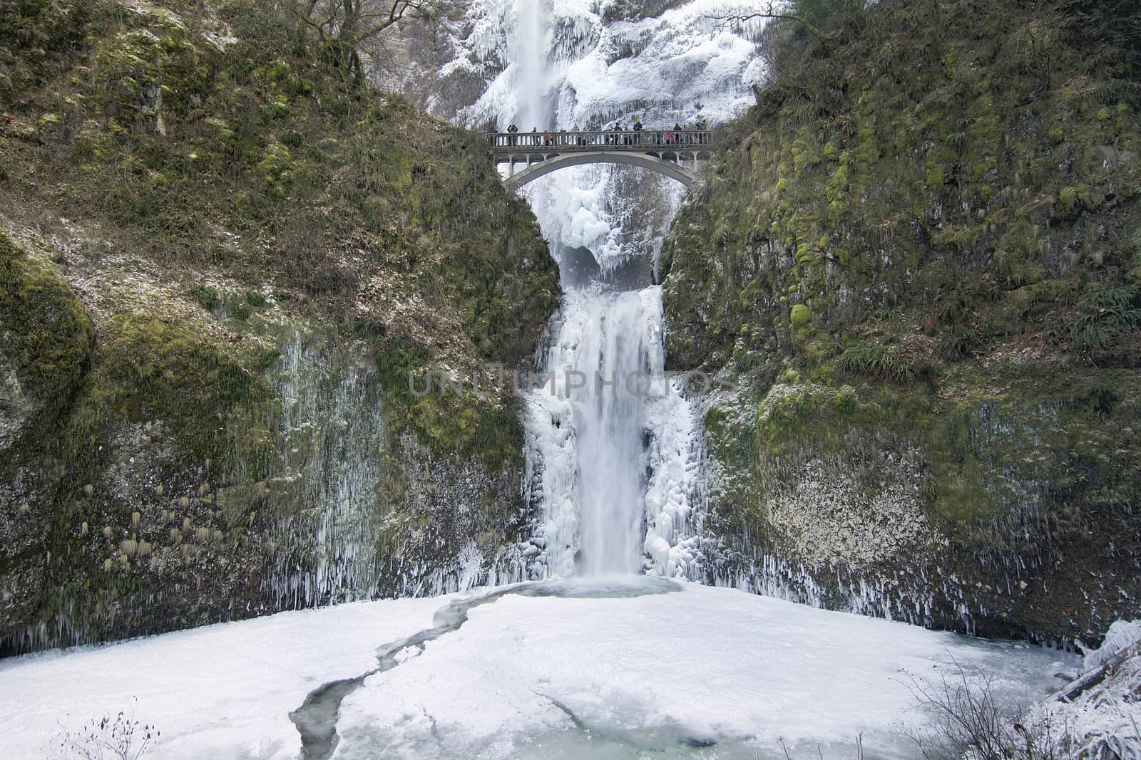 Bridge with People Faces Blurred Over Multnomah Falls at Columbia River Gorge Oregon Frozen in Winter Season