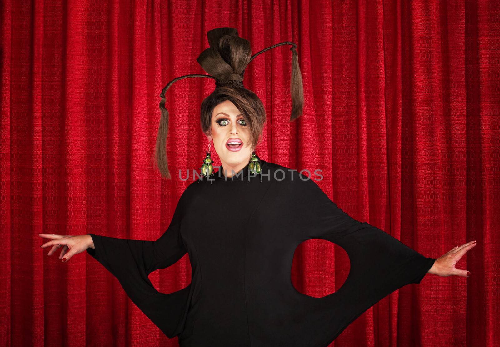Smiling man in drag wearing unique dress and hairdo