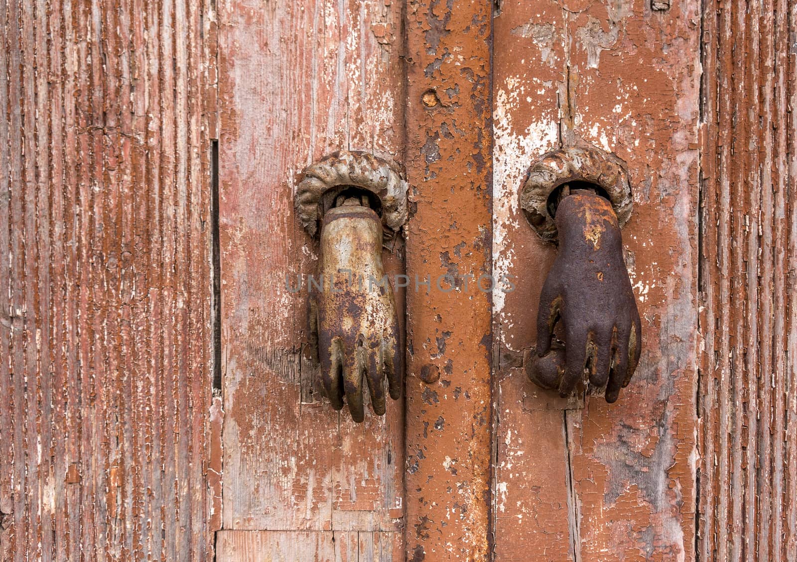 Old bronze knocker on a wooden door