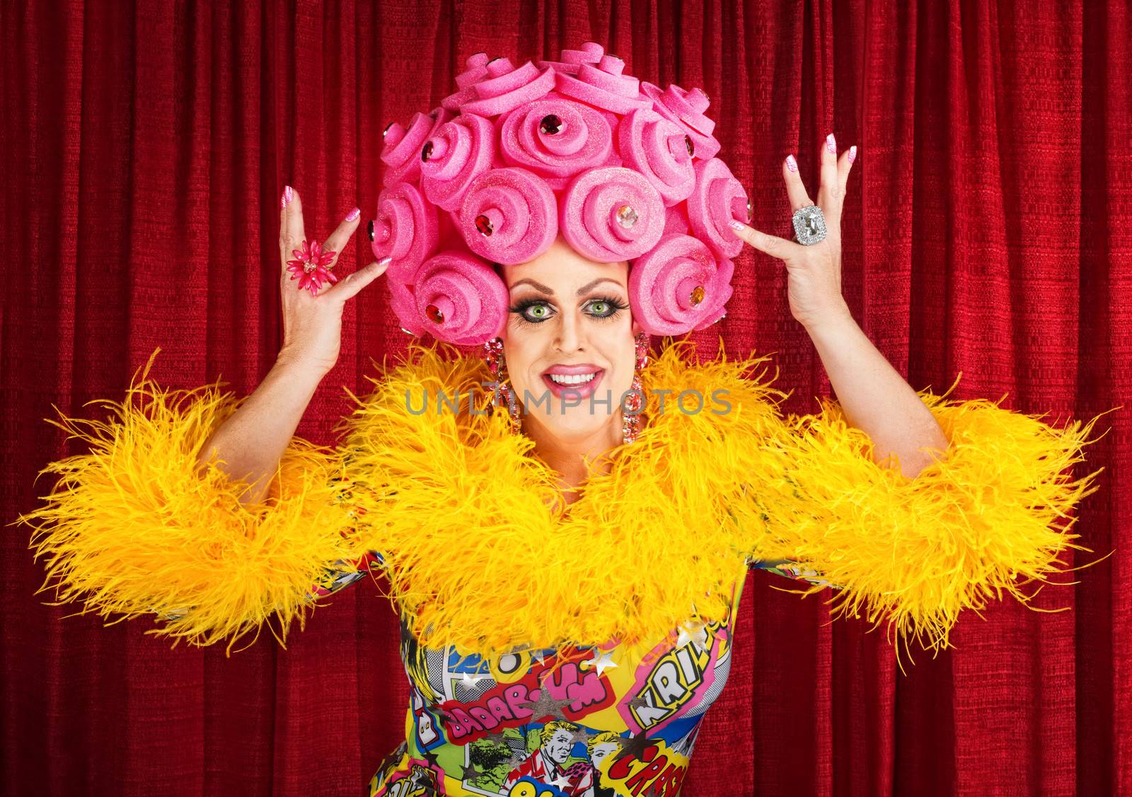 Happy man in dress and pink foam wig performing