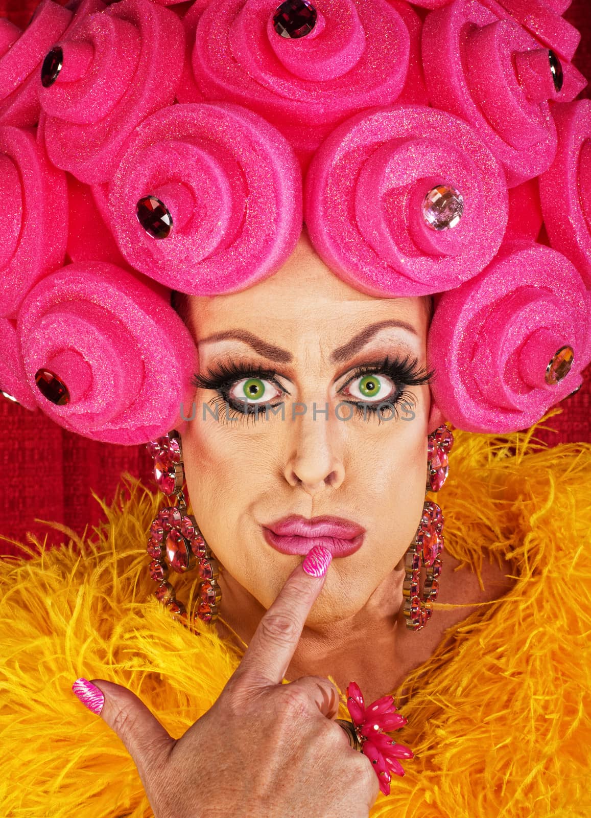 Serious cross dressing man with finger on lips