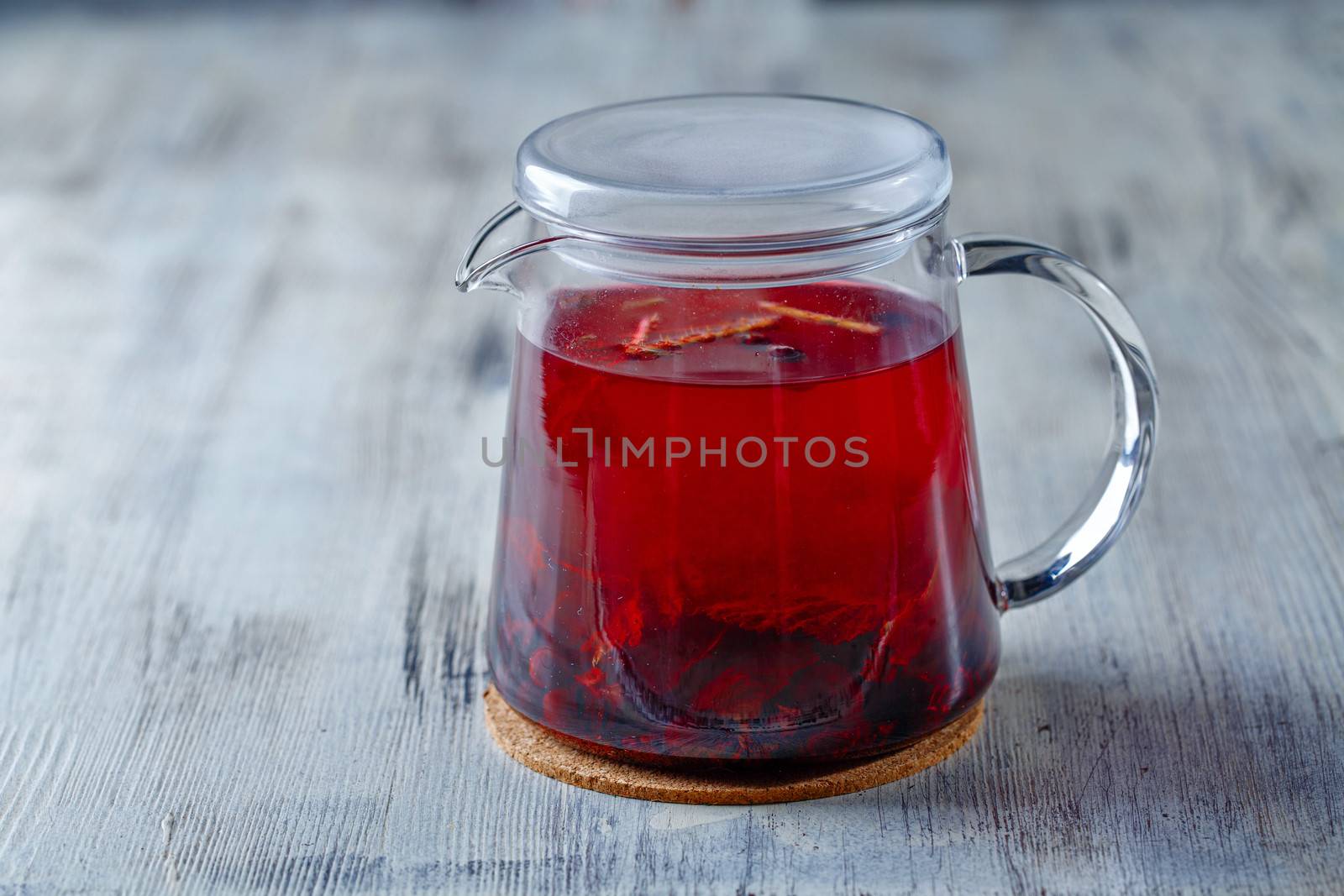 Glass tea kettle on the wooden table closeup shot