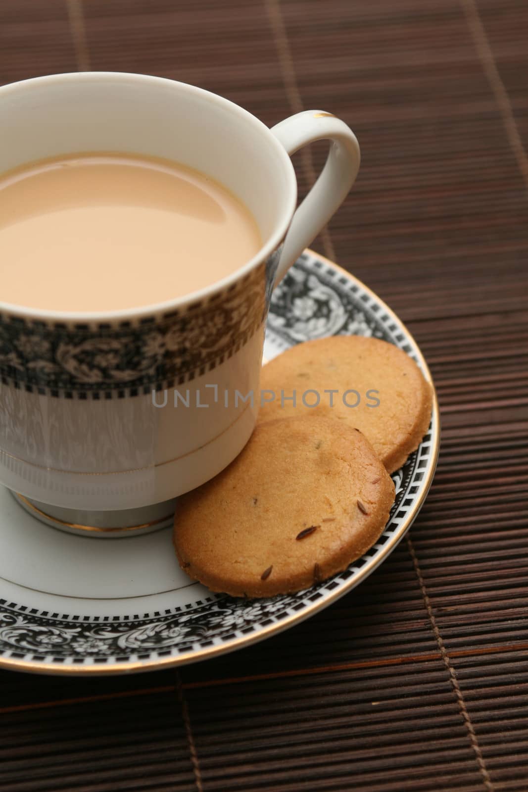 A cup of tea with biscuits by haiderazim