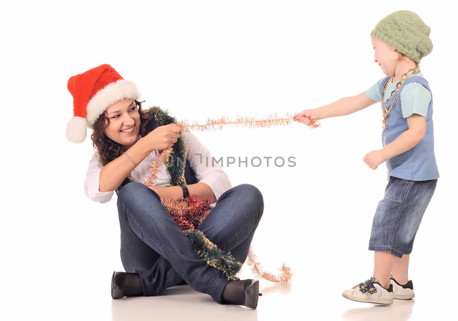 Girl in a santa hat playing with a boy by dedmorozz