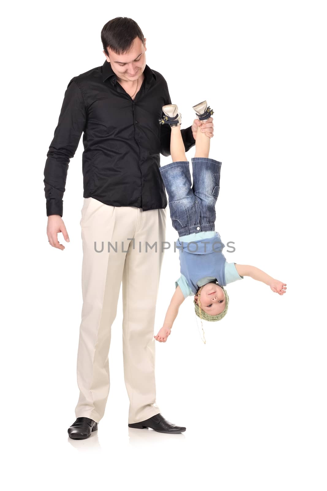Man holds little boy upside down by dedmorozz