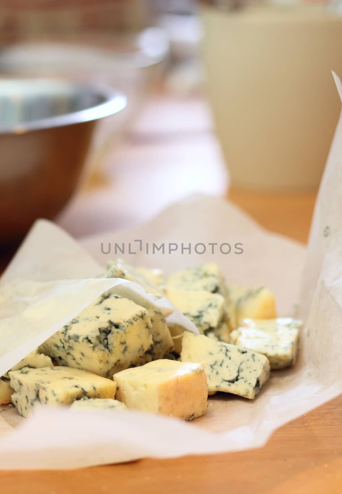 Pieces of a blue cheese on a kitchen by dedmorozz