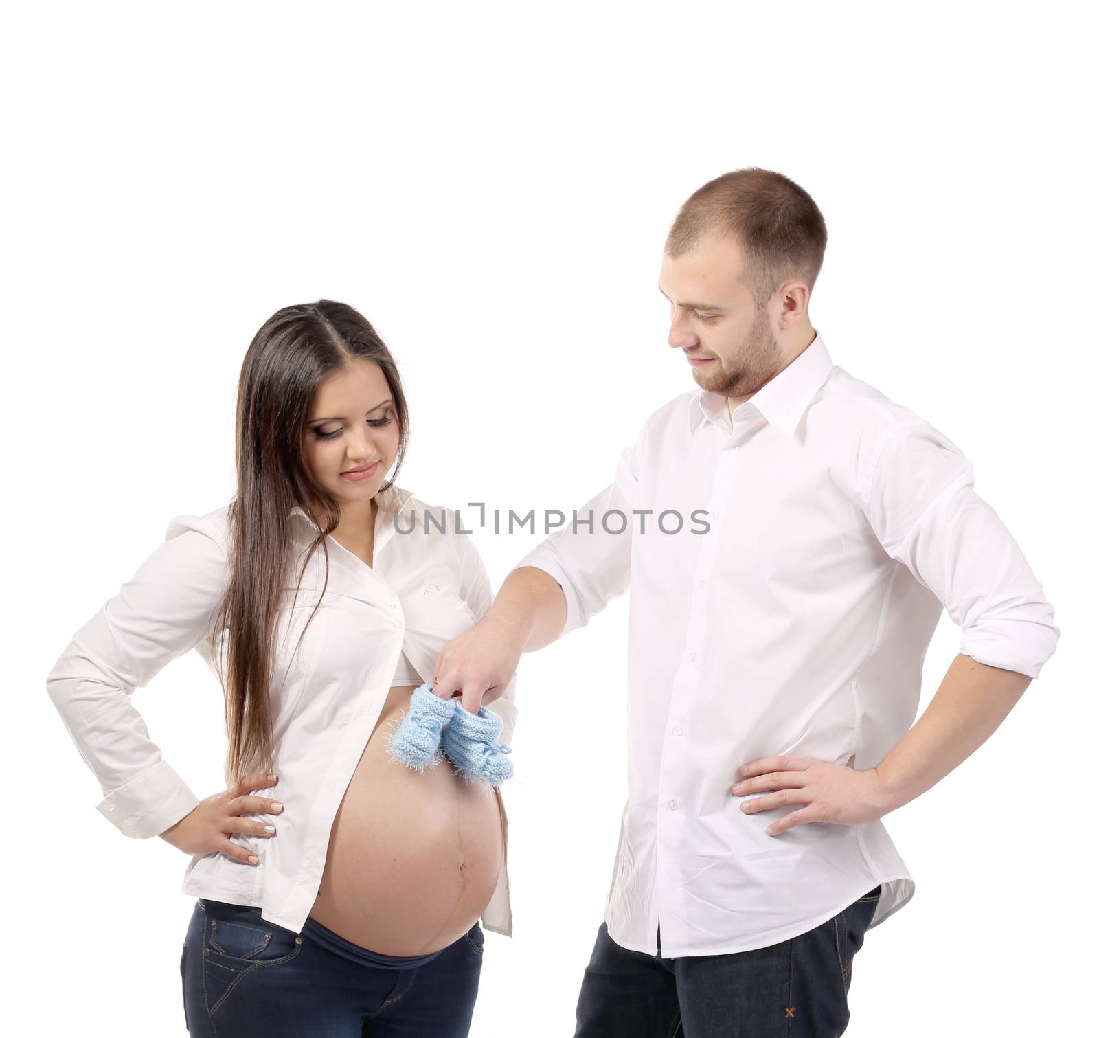 Beautiful couple expecting a baby. Isolated on a white background.