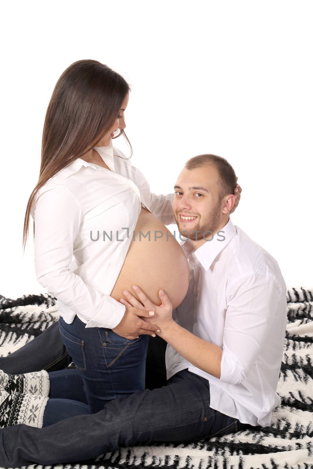 Happy men smiling with pregnant woman. Isolated on a white background.