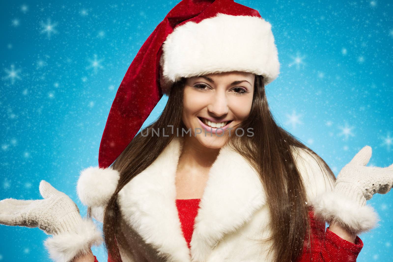Christmas girl. Beautiful happy woman with santa hat 