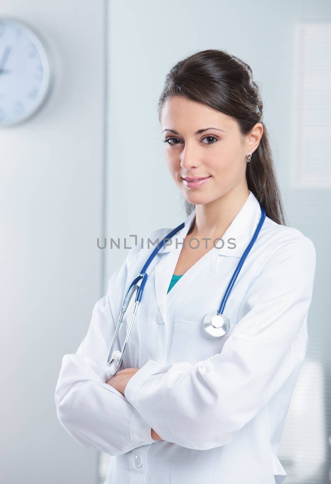 Portrait of a smiling woman doctor with her arms crossed