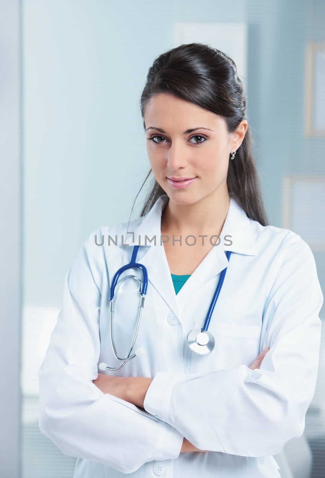 Portrait of a smiling woman doctor with her arms crossed