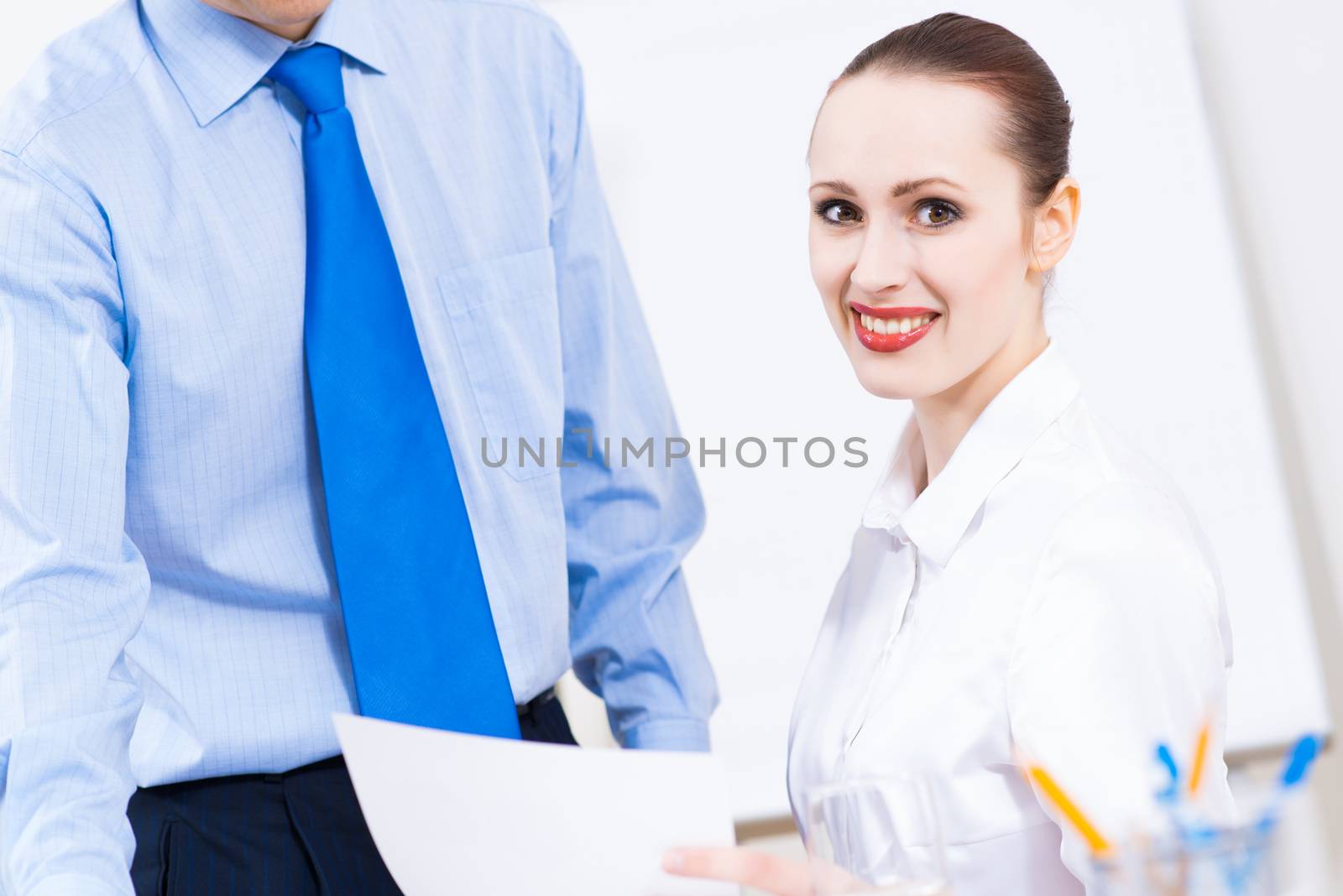 colleagues discuss the reports at a desk in the office, working together in business