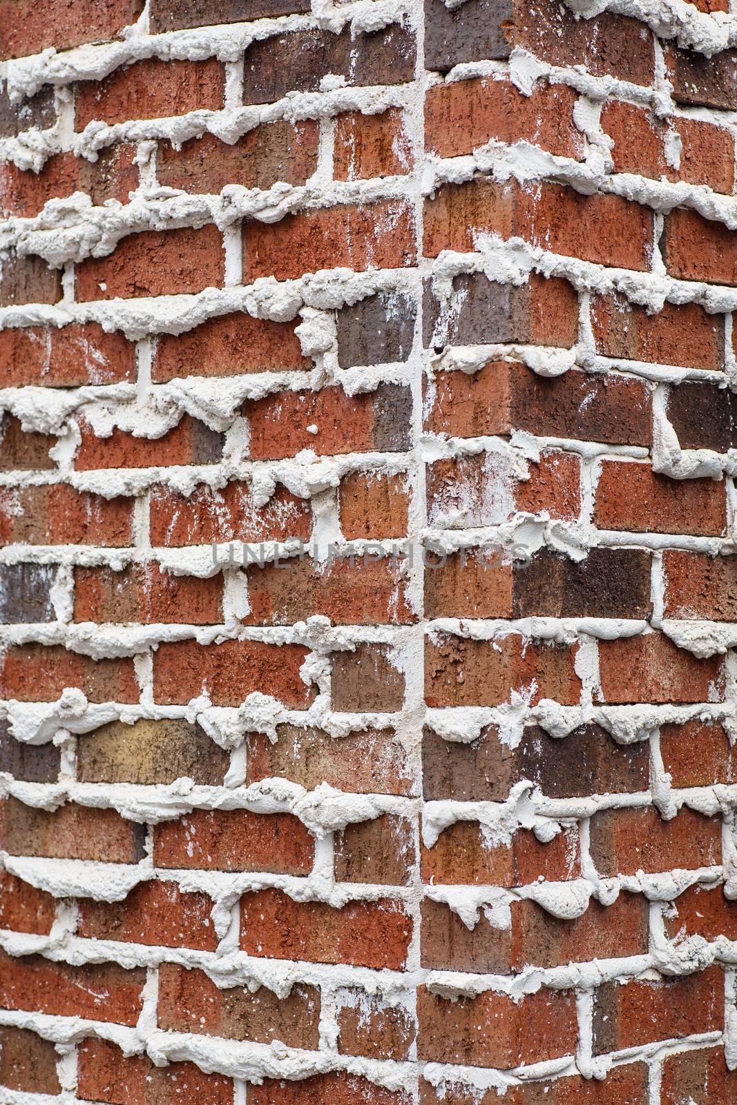 A brick wall with mortar extruding from joints good for background or texture