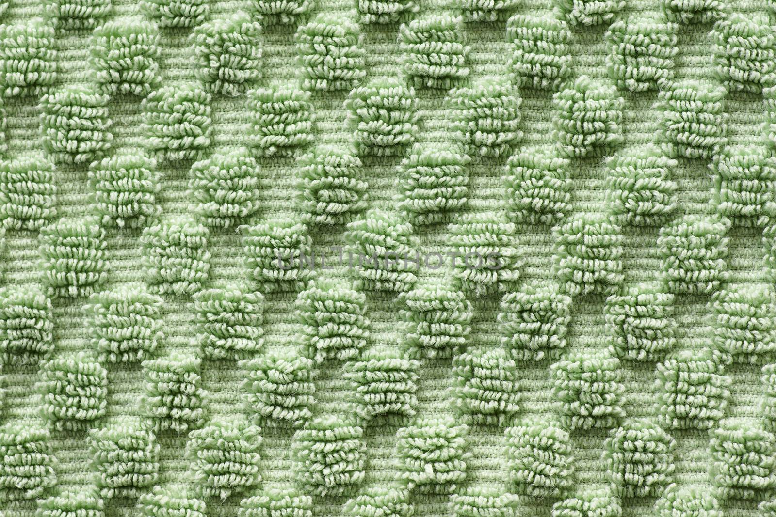 Macro shot of soft green towel with square pattern, green texture and background.